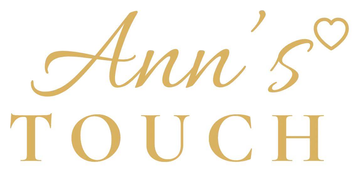 The Ann's Touch wordmark, gold script lettering with a heart above serif capitals